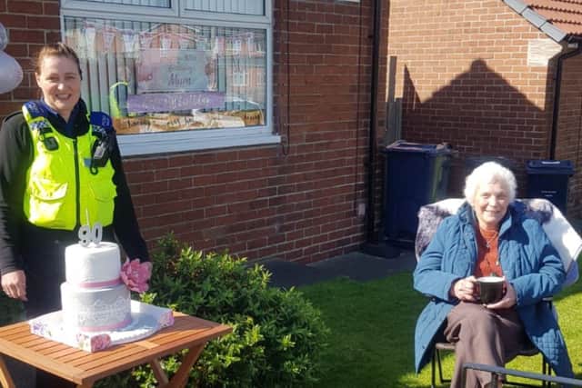 Mary celebrating her 90th birthday with PC Neil Morris and PCSO Gayle Muizelaar. 
Image by Northumbria Police.