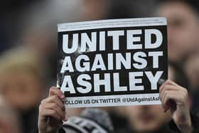 NEWCASTLE UPON TYNE, ENGLAND - JANUARY 29: A fan holds up a 'United Against Ashley' card during the Premier League match between Newcastle United and Manchester City at St. James Park on January 29, 2019 in Newcastle upon Tyne, United Kingdom. (Photo by Stu Forster/Getty Images)