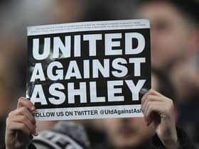 NEWCASTLE UPON TYNE, ENGLAND - JANUARY 29: A fan holds up a 'United Against Ashley' card during the Premier League match between Newcastle United and Manchester City at St. James Park on January 29, 2019 in Newcastle upon Tyne, United Kingdom. (Photo by Stu Forster/Getty Images)