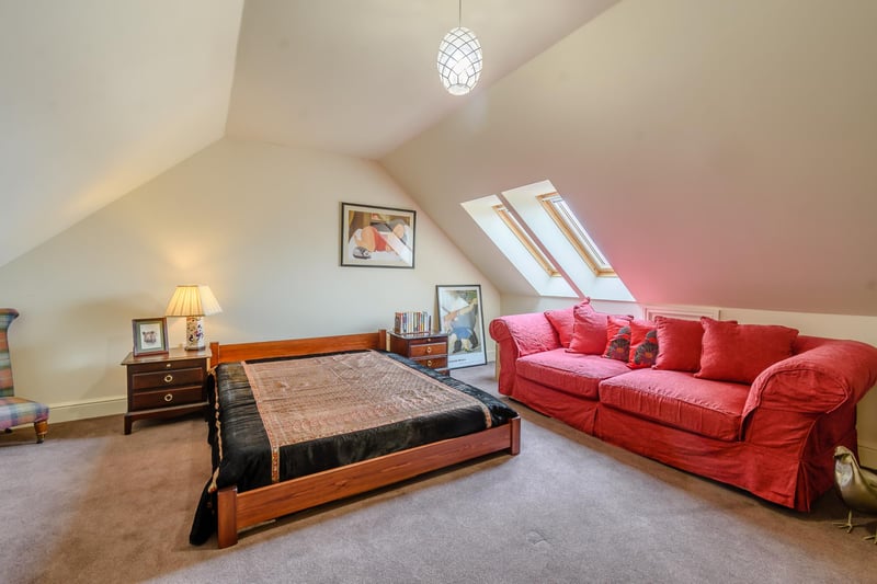 The property’s large remaining bedroom with vaulted ceiling is on the second floor.
