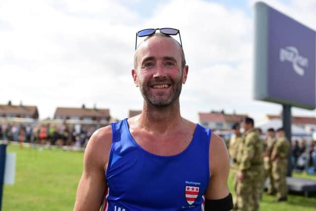 Tim Jones, from Washington, stops for a picture at the end of the 2021 Great North Run.