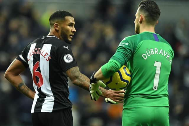 NEWCASTLE UPON TYNE, ENGLAND - FEBRUARY 01: Jamaal Lascelles of Newcastle United with team mate Martin Dubravka at the final whistle during the Premier League match between Newcastle United and Norwich City at St. James Park on February 01, 2020 in Newcastle upon Tyne, United Kingdom. (Photo by Mark Runnacles/Getty Images)