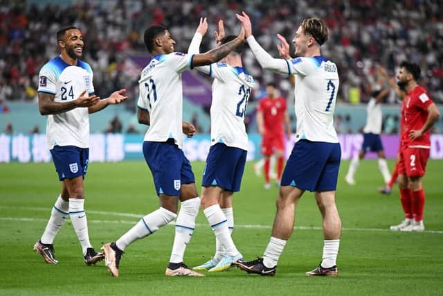 Jack Grealish celebrates with Callum Wilson and Marcus Rashford  after scoring their team's sixth goal during the FIFA World Cup Qatar 2022 Group B match between England and IR Iran at Khalifa International Stadium on November 21, 2022 in Doha, Qatar. (Photo by Matthias Hangst/Getty Images)