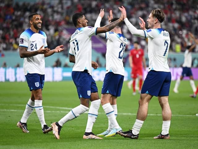 Jack Grealish celebrates with Callum Wilson and Marcus Rashford  after scoring their team's sixth goal during the FIFA World Cup Qatar 2022 Group B match between England and IR Iran at Khalifa International Stadium on November 21, 2022 in Doha, Qatar. (Photo by Matthias Hangst/Getty Images)