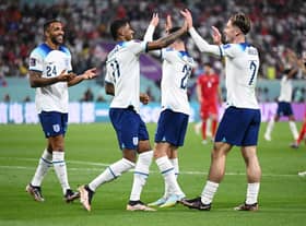 Jack Grealish celebrates with Callum Wilson and Marcus Rashford  after scoring their team's sixth goal during the FIFA World Cup Qatar 2022 Group B match between England and IR Iran at Khalifa International Stadium on November 21, 2022 in Doha, Qatar. (Photo by Matthias Hangst/Getty Images)