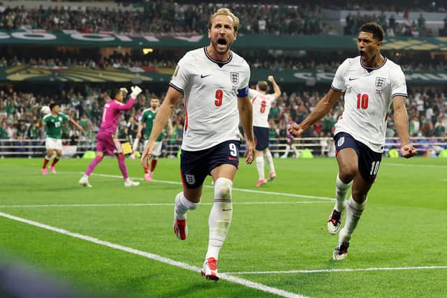 Harry Kane celebrates with Jude Bellingham converting a penalty for his team’s third goal during the Mexico-England game. (Photo by Charlotte Wilson/Getty Images)