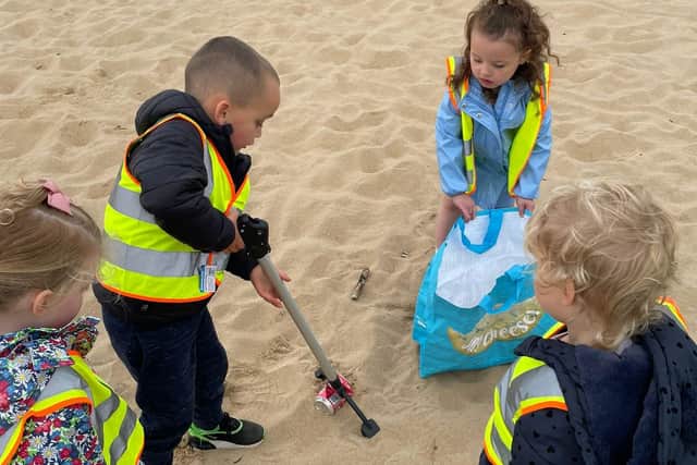 Children from Beach Hill Nursery tidying up the beach