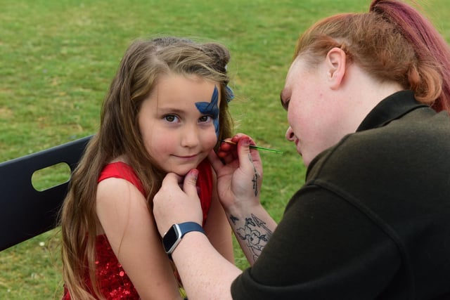 Lily Beth day having her face painted by Nicola Cole of Krazy Bounce.