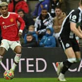 Manchester United's English striker Marcus Rashford (L) looks to play a pass during the English Premier League football match between Newcastle United and Manchester United at St James' Park in Newcastle-upon-Tyne, north east England on December 27, 2021.  (Photo by PAUL ELLIS/AFP via Getty Images)