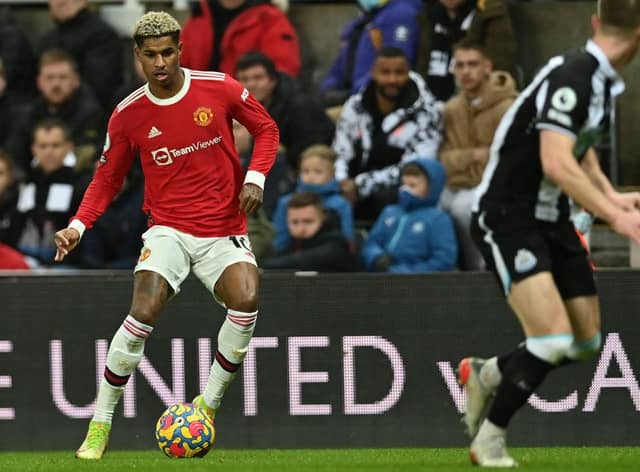 Manchester United's English striker Marcus Rashford (L) looks to play a pass during the English Premier League football match between Newcastle United and Manchester United at St James' Park in Newcastle-upon-Tyne, north east England on December 27, 2021.  (Photo by PAUL ELLIS/AFP via Getty Images)