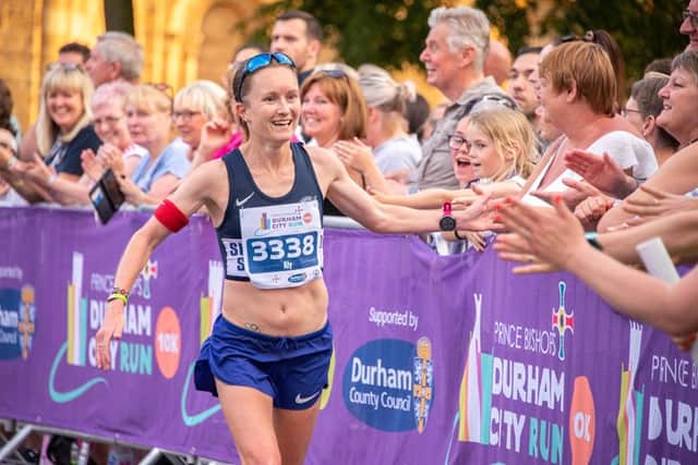 Sunderland's Team GB marathon star Aly Dixon high fives spectators during the 2019 Prince Bishops Durham City 10k