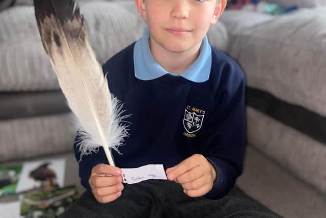 Dylan Barney with some of his feathers.