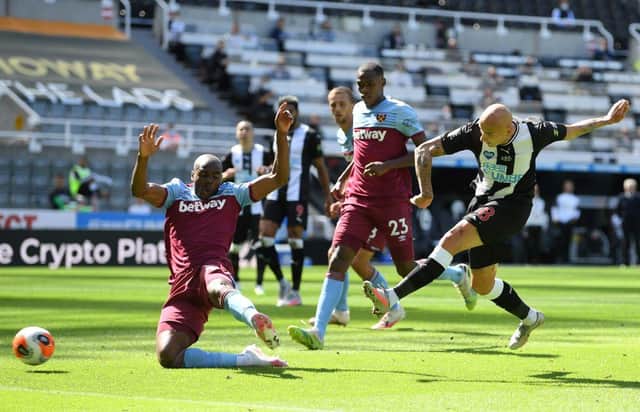 Newcastle United's English midfielder Jonjo Shelvey (R) shoots and scores a goal during the English Premier League football match between Newcastle United and West Ham United at St James' Park in Newcastle-upon-Tyne, north east England on July 5, 2020.