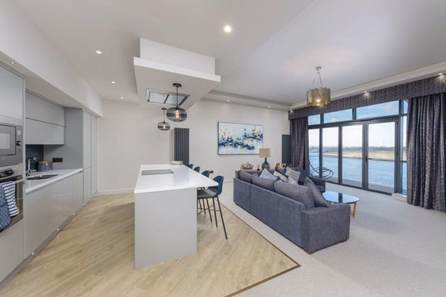 The impressive open plan lounge/kitchen and dining space has private balcony with wonderful views over the river.