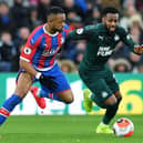 Crystal Palace's French-born Ghanaian striker Jordan Ayew (L) vies with Newcastle United's English defender Danny Rose during the English Premier League football match between Crystal Palace and Newcastle United at Selhurst Park in south London on February 22, 2020.