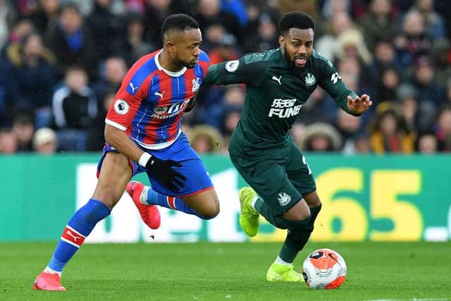 Crystal Palace's French-born Ghanaian striker Jordan Ayew (L) vies with Newcastle United's English defender Danny Rose during the English Premier League football match between Crystal Palace and Newcastle United at Selhurst Park in south London on February 22, 2020.