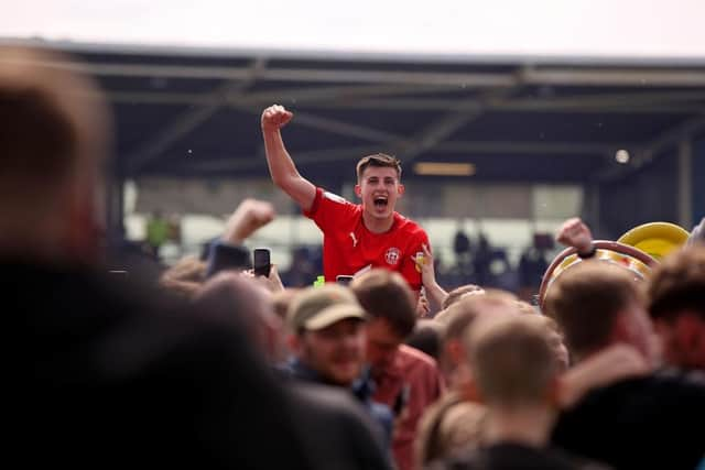 Kelland Watts celebrates promotion with loan club Wigan Athetlic last season.