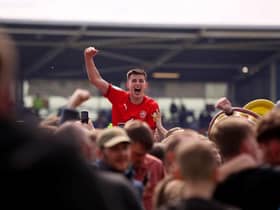 Kelland Watts celebrates promotion with loan club Wigan Athetlic last season.