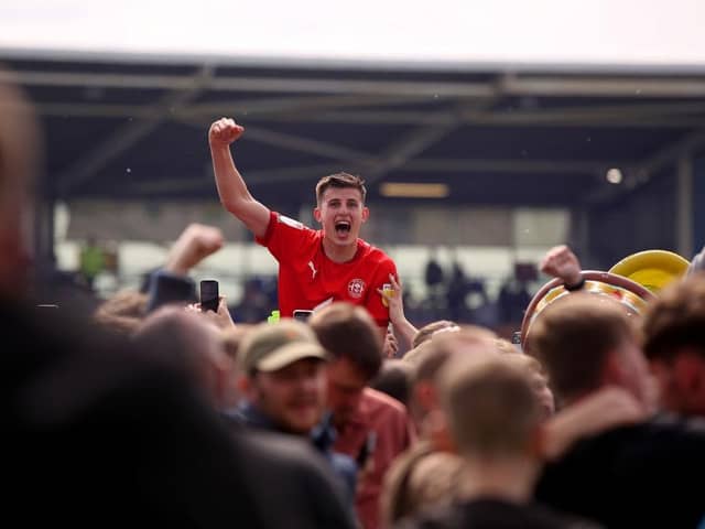 Kelland Watts celebrates promotion with loan club Wigan Athetlic last season.