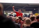 Kelland Watts celebrates promotion with loan club Wigan Athetlic last season.