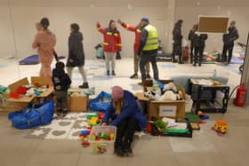 PRZEMYSL, POLAND - MARCH 03: A mother and child who have fled from war in Ukraine sit among donated toys at a temporary shelter set up in a former shopping center on March 03, 2022 in Przemysl, Poland. Most arrivees spend only a short time at the shelter before being picked up by relatives among the Ukrainian diaspora or traveling onward by bus or train. Over one million people have left Ukraine since Russian launched its military invasion one week ago. (Photo by Sean Gallup/Getty Images)