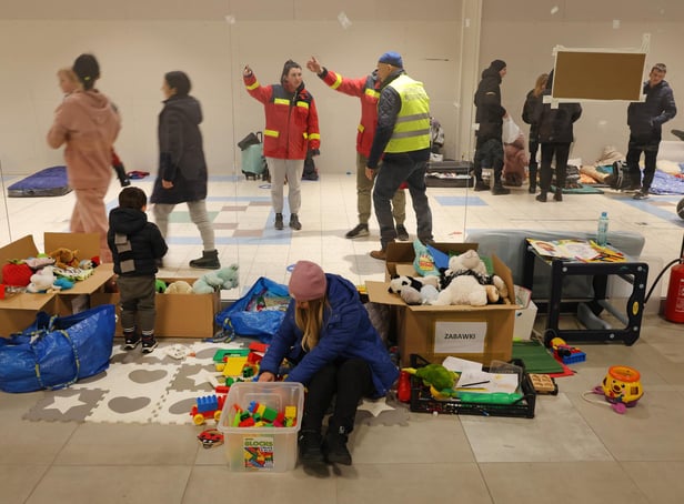 PRZEMYSL, POLAND - MARCH 03: A mother and child who have fled from war in Ukraine sit among donated toys at a temporary shelter set up in a former shopping center on March 03, 2022 in Przemysl, Poland. Most arrivees spend only a short time at the shelter before being picked up by relatives among the Ukrainian diaspora or traveling onward by bus or train. Over one million people have left Ukraine since Russian launched its military invasion one week ago. (Photo by Sean Gallup/Getty Images)