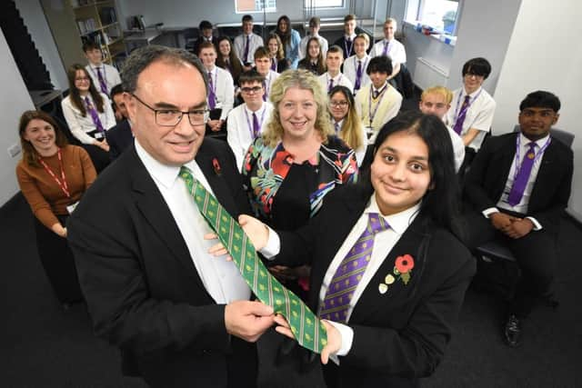 Governor of the Bank of England Andrew Bailey is presented with a gift from Shreya Bhardwaj.