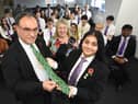 Governor of the Bank of England Andrew Bailey is presented with a gift from Shreya Bhardwaj.