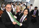 Governor of the Bank of England Andrew Bailey is presented with a gift from Shreya Bhardwaj.