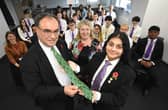 Governor of the Bank of England Andrew Bailey is presented with a gift from Shreya Bhardwaj.