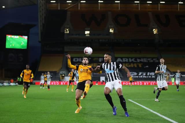 Pedro Neto of Wolverhampton Wanderers battles for possession with Jamaal Lascelles.