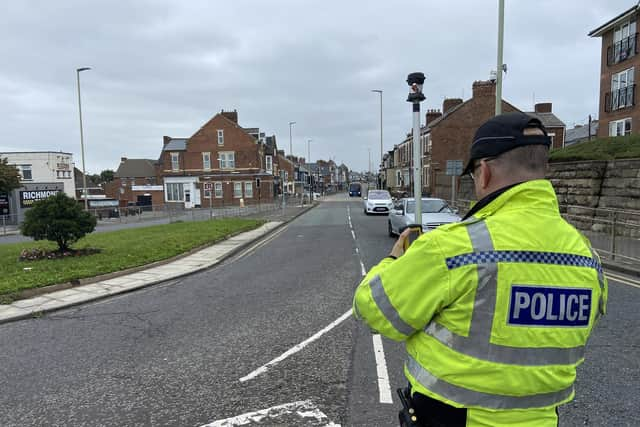 A police officer takes details of measurements on Westoe Road, close to the scene of the collision.