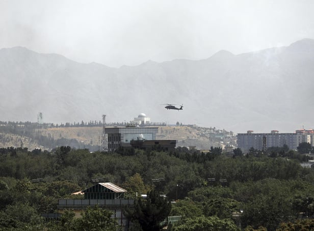 A. US Black Hawk military helicopter flies over the city of Kabul, Afghanistan, Sunday, Aug. 15, 2021. Taliban fighters entered the outskirts of the Afghan capital on Sunday and said they were awaiting a 'peaceful transfer' of the city after promising not to take it by force, but amid the uncertainty panicked workers fled government offices and helicopters landed at the US Embassy. (AP Photo/Rahmat Gul)