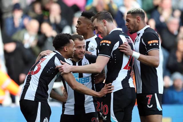 Jacob Murphy of Newcastle United congratulates team mate Ryan Fraser on his opening goal during the Premier League match between Newcastle United and Brighton & Hove Albion at St. James Park on March 05, 2022 in Newcastle upon Tyne, England. (Photo by Ian MacNicol/Getty Images)