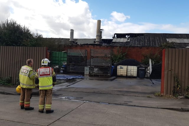 Firefighters assessing the damage caused by the fire.

Photograph: TWFRS