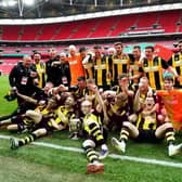 Hebburn Town players and staff celebrate with the Buildbase FA Vase 2019/20 Trophy after the Final at Wembley Stadium, London.