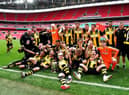 Hebburn Town players and staff celebrate with the Buildbase FA Vase 2019/20 Trophy after the Final at Wembley Stadium, London.
