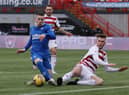 HAMILTON, SCOTLAND - FEBRUARY 07: Ryan Kent of Rangers has an attempt at goal whilst under pressure from Jamie Hamilton of Hamilton Academical during the Ladbrokes Scottish Premiership match between Hamilton Academical and Rangers at Hope CBD Stadium on February 07, 2021 in Hamilton, Scotland. Sporting stadiums around the UK remain under strict restrictions due to the Coronavirus Pandemic as Government social distancing laws prohibit fans inside venues resulting in games being played behind closed doors. (Photo by Ian MacNicol/Getty Images)