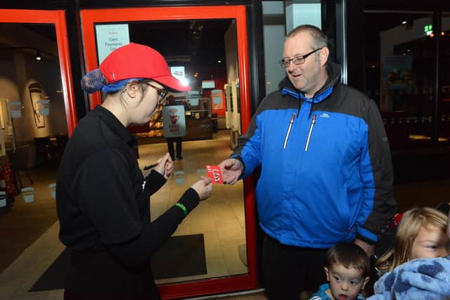 First customer Carl Tudor receives a a year of free coffee.