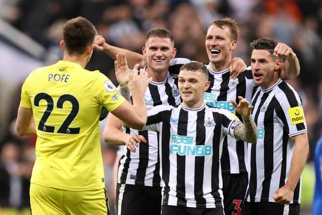 Nick Pope of Newcastle United joins in with the celebrations as team mates Sven Botman, Kieran Trippier, Dan Burn and Fabian Schar celebrates their side's win after the final whistle of the Premier League match between Newcastle United and Everton FC at St. James Park on October 19, 2022 in Newcastle upon Tyne, England. (Photo by George Wood/Getty Images)