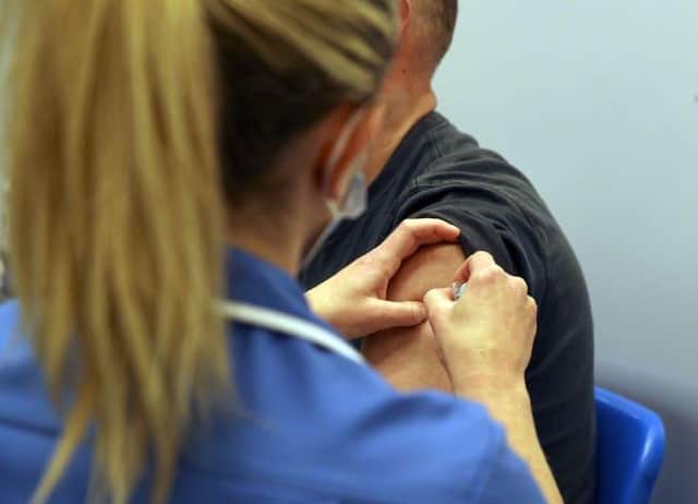 A coronavirus vaccination being administered