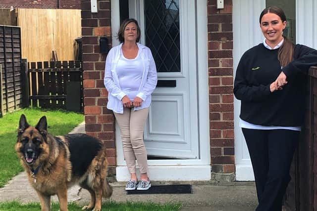 Janette Bowman (left) and Charlotte Luther, senior physiotherapist at Connect Health with Teddy the dog.