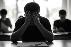 A young person getting stressed during an exam can be a common occurrence. Photo posed by a model