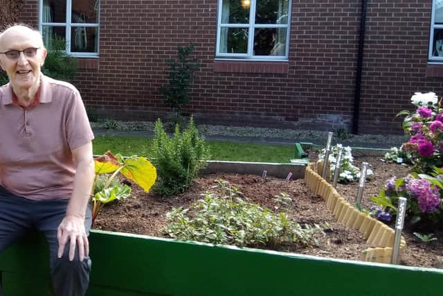 Willowdene Care Home resident Harry Tweddle, 68, with one of the sensory garden flower beds created by students from Sunderland AFC’s Foundation of Light National Citizenship Service.
