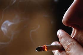 A woman is seen smoking a cigarette (Photo by Jeff J Mitchell/Getty Images)