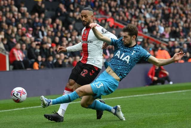 Theo Walcott of Southampton is tackled by Ben Davies of Tottenham Hotspur during the Premier League match between Southampton FC and Tottenham Hotspur at Friends Provident St. Mary's Stadium on March 18, 2023 in Southampton, England. (Photo by Mike Hewitt/Getty Images)