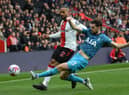 Theo Walcott of Southampton is tackled by Ben Davies of Tottenham Hotspur during the Premier League match between Southampton FC and Tottenham Hotspur at Friends Provident St. Mary's Stadium on March 18, 2023 in Southampton, England. (Photo by Mike Hewitt/Getty Images)
