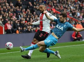 Theo Walcott of Southampton is tackled by Ben Davies of Tottenham Hotspur during the Premier League match between Southampton FC and Tottenham Hotspur at Friends Provident St. Mary's Stadium on March 18, 2023 in Southampton, England. (Photo by Mike Hewitt/Getty Images)