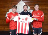 SAFC players Jack Clarke and Anthony Patterson holding the special edition Foundation of Light shirt alongside Great Annual Savings Group’s operations director Craig Shields.
