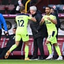 Dwight Gayle of Newcastle United is replaced by Callum Wilson of Newcastle United during the Premier League match between Burnley and Newcastle United at Turf Moor on April 11, 2021 in Burnley, England.